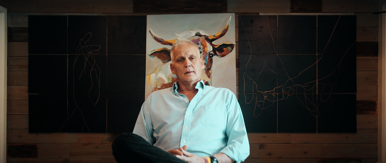 Groom sitting in chair being interviewed.