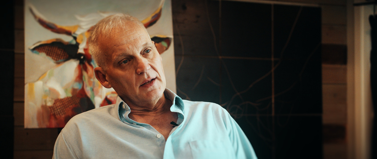 Groom sitting in chair, close up, speaking.