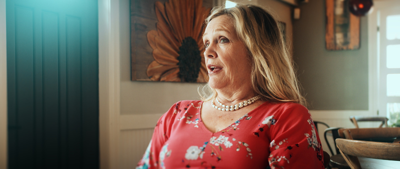 Bride sitting in chair, being interviewed.