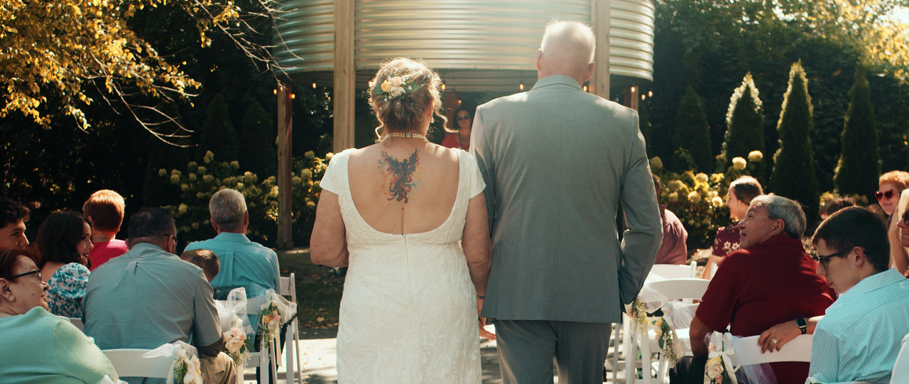 Bride and Groom walk down aisle together.