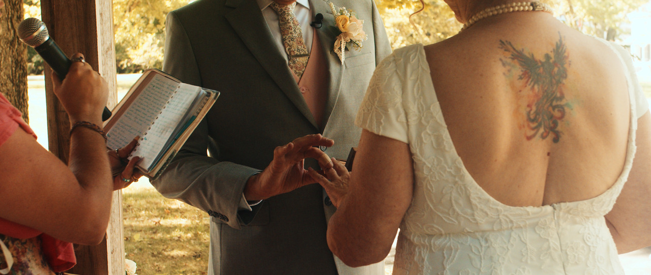 Groom places ring on bride's finger.