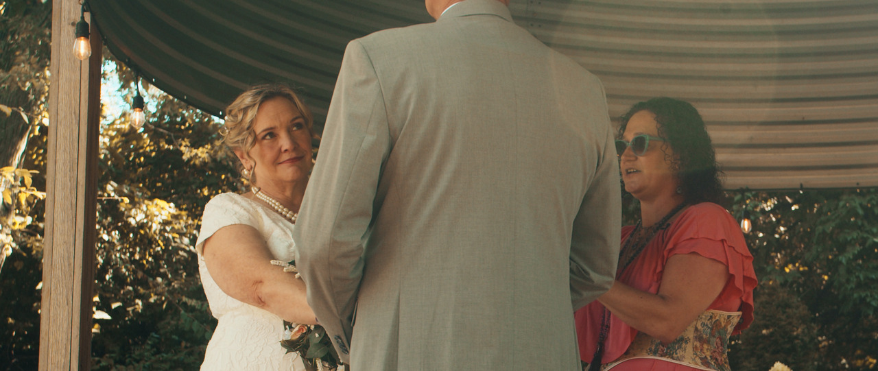 Bride smirks at groom.