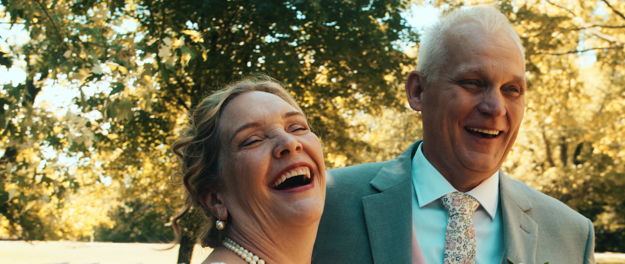 Bride and groom laughing.