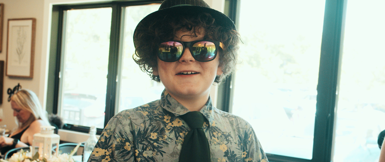 Cute child with sunglasses and fedora.