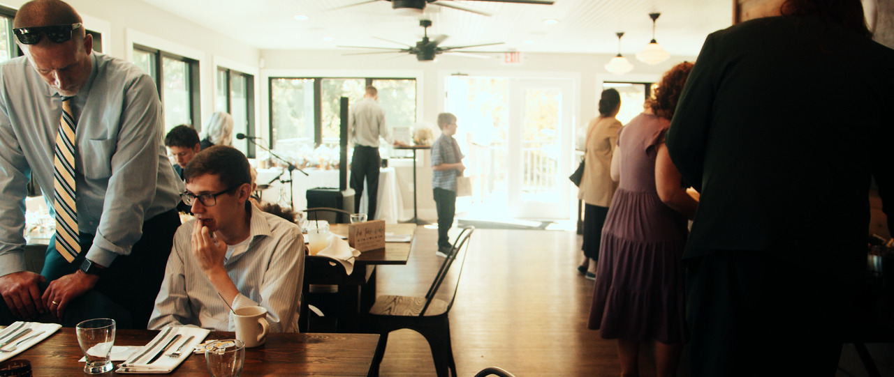 Wedding guests enjoy reception.