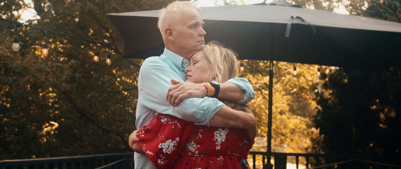 Bride and groom hugging on porch.