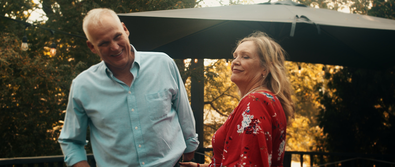 Bride and groom laughing together.