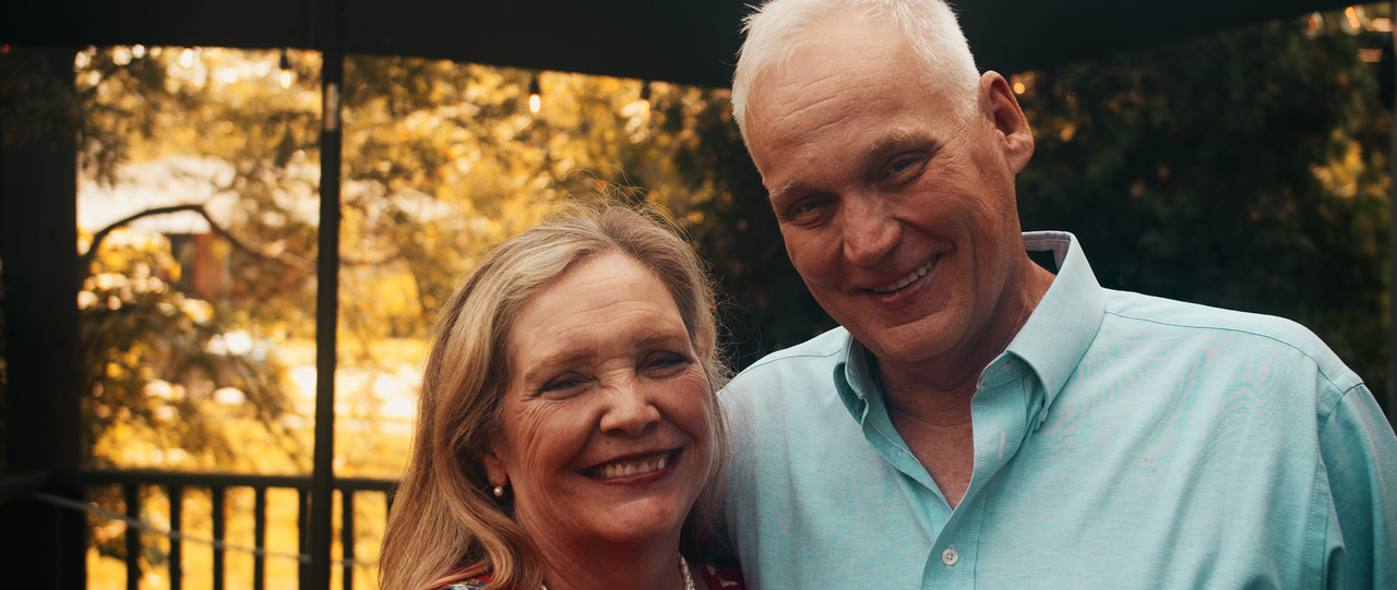 Bride and groom smiling at camera.