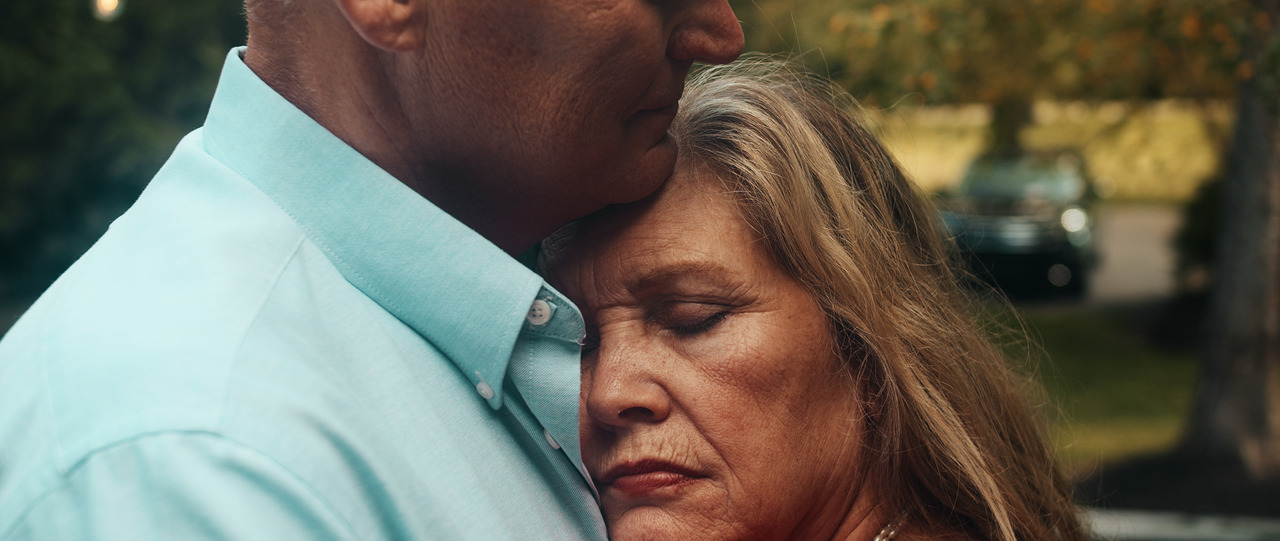 Bride resting while groom holds her.