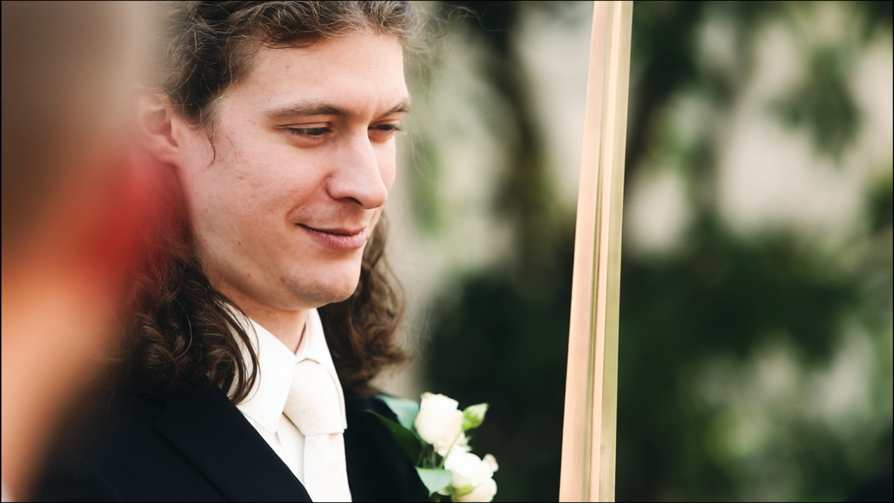 Groom holding sword.