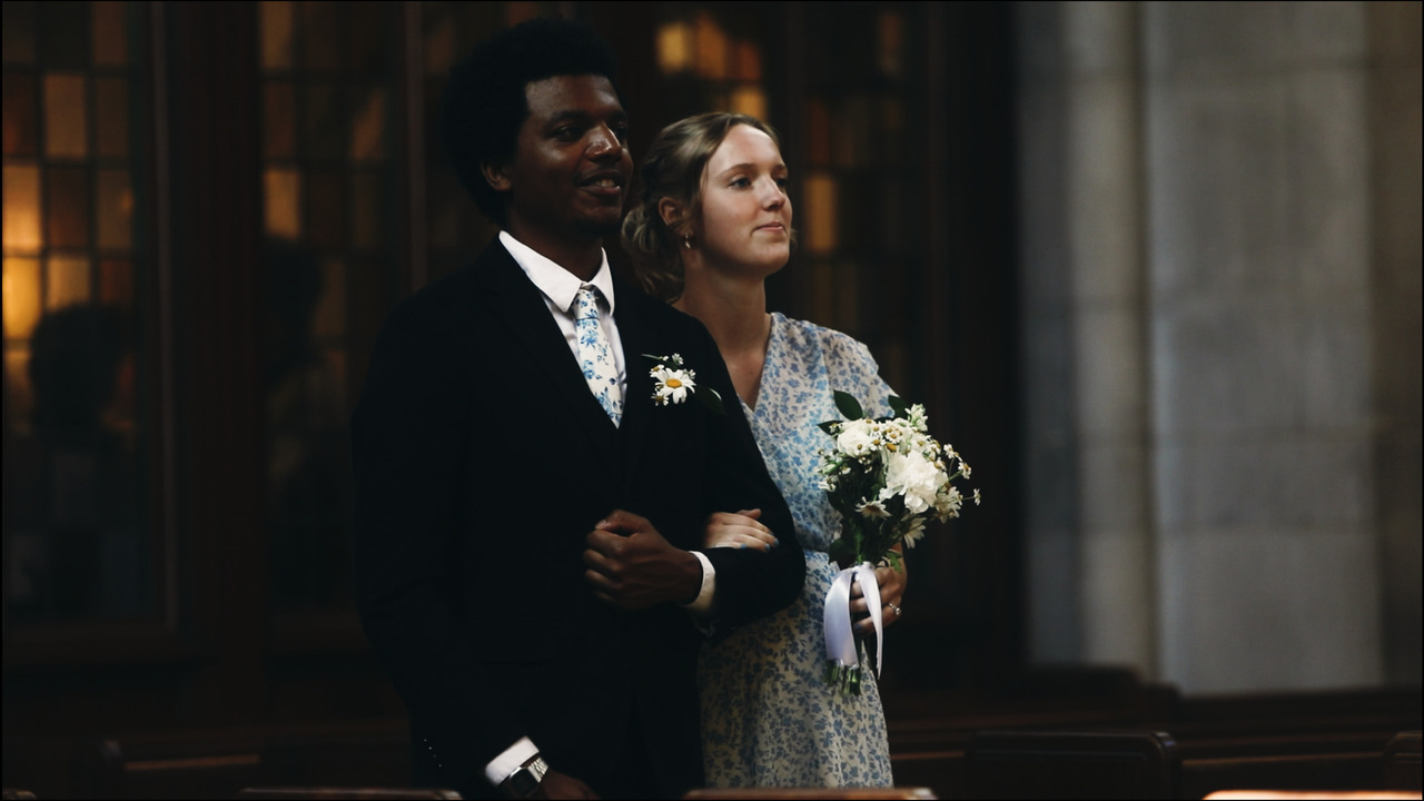 Groomsman and bridesmaid walking down aisle.