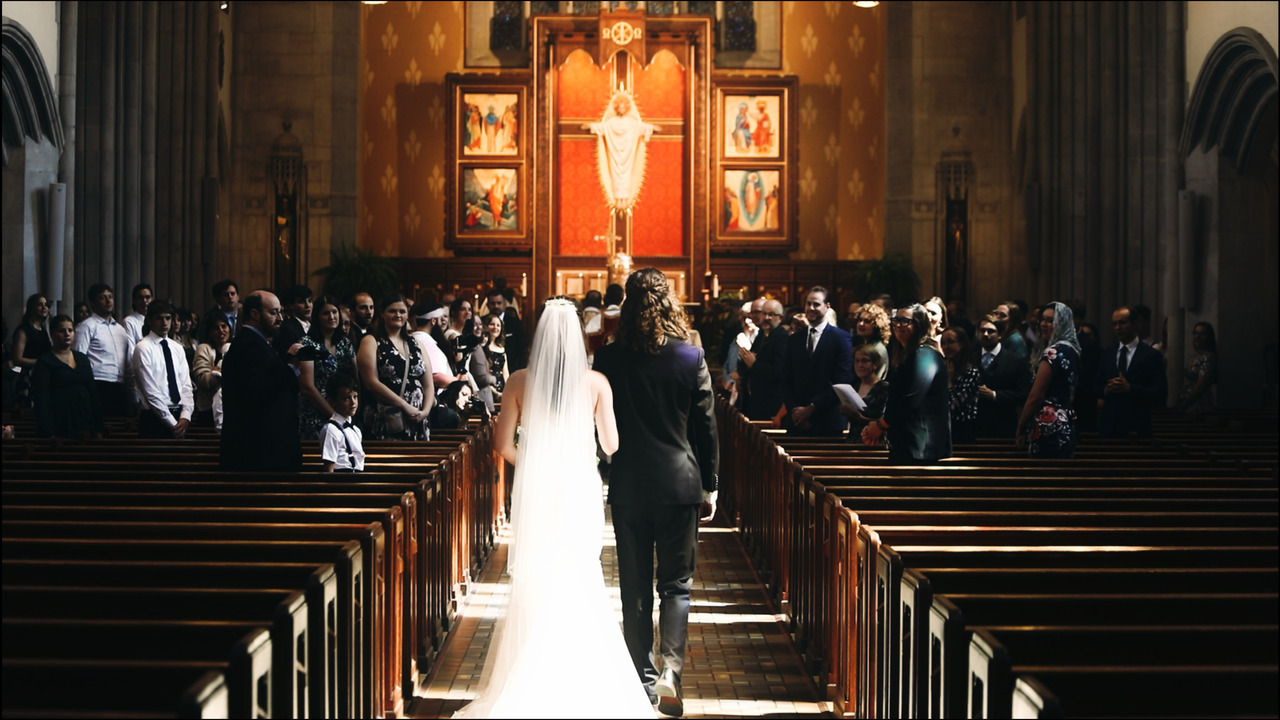 Bride and Groom walking down aisle together.