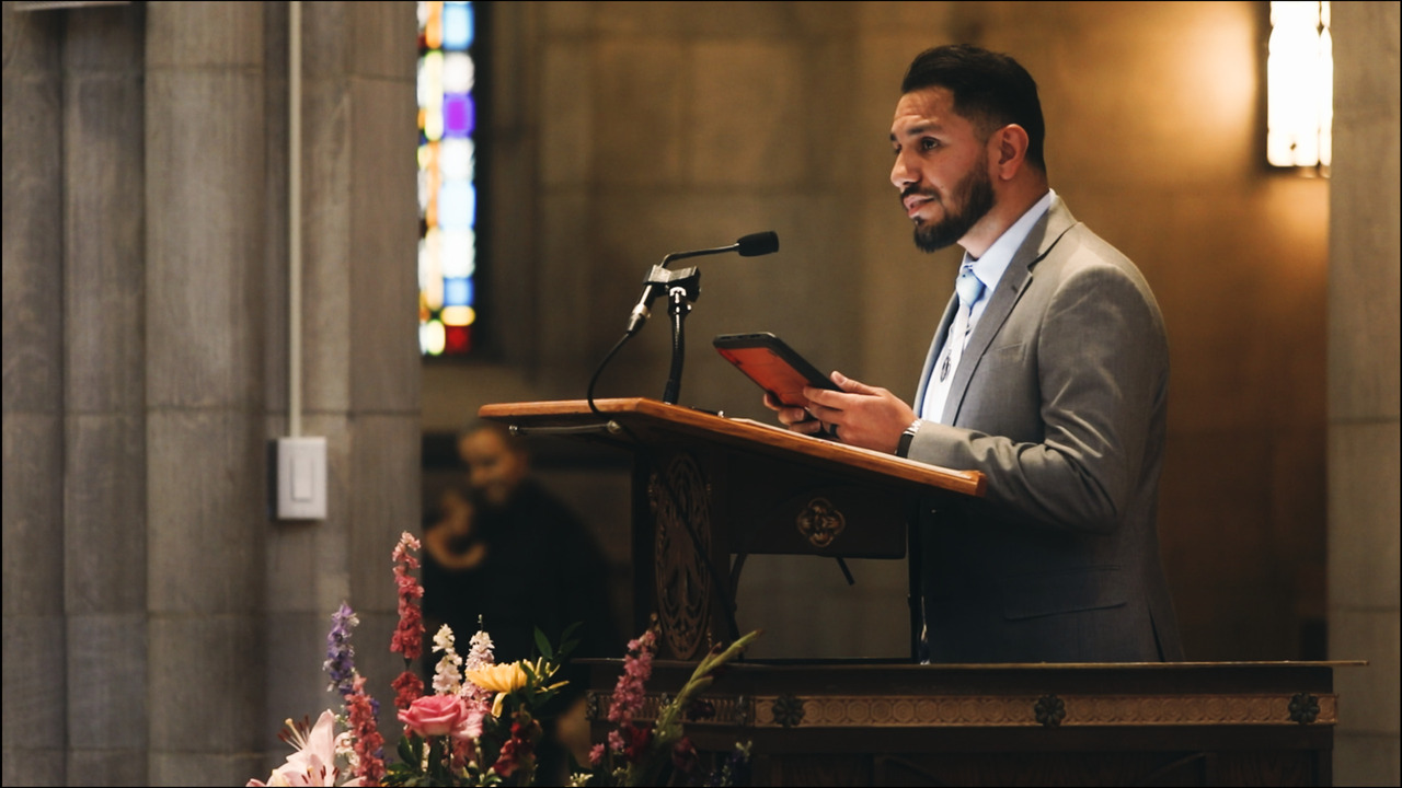Lector reading from pulpit.