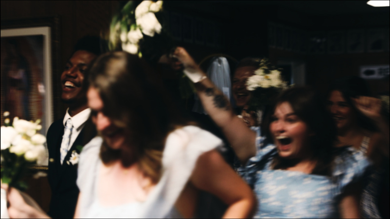 Bridal party cheering as they enter reception.