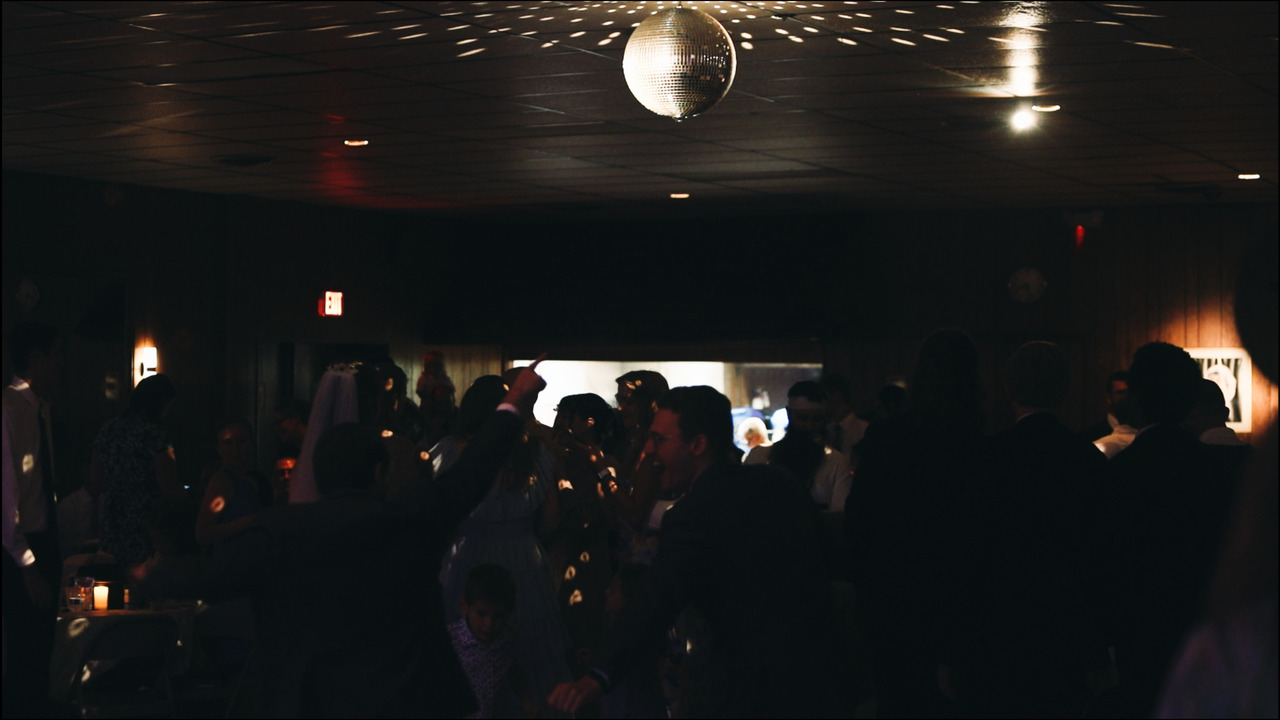 Reception guests dance.