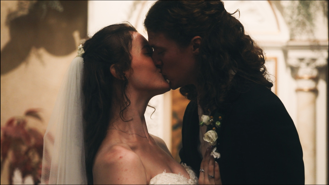 Bride and groom kiss.