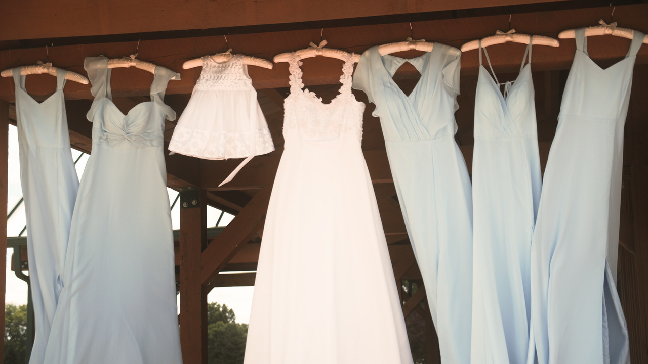 Wedding dresses: bride, bridesmaids, and flower girl, all hand from porch roof.