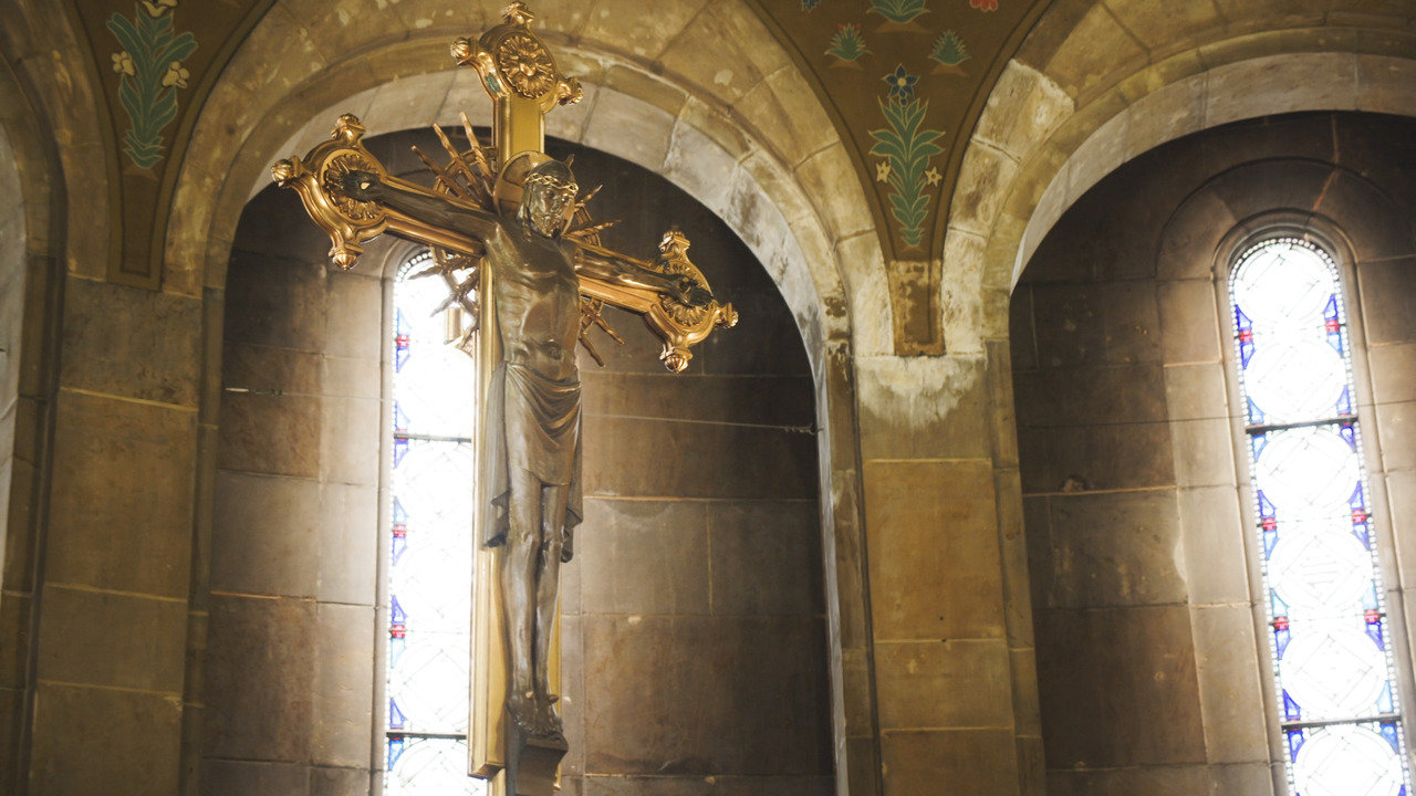 Large gilded crucifix above altar.