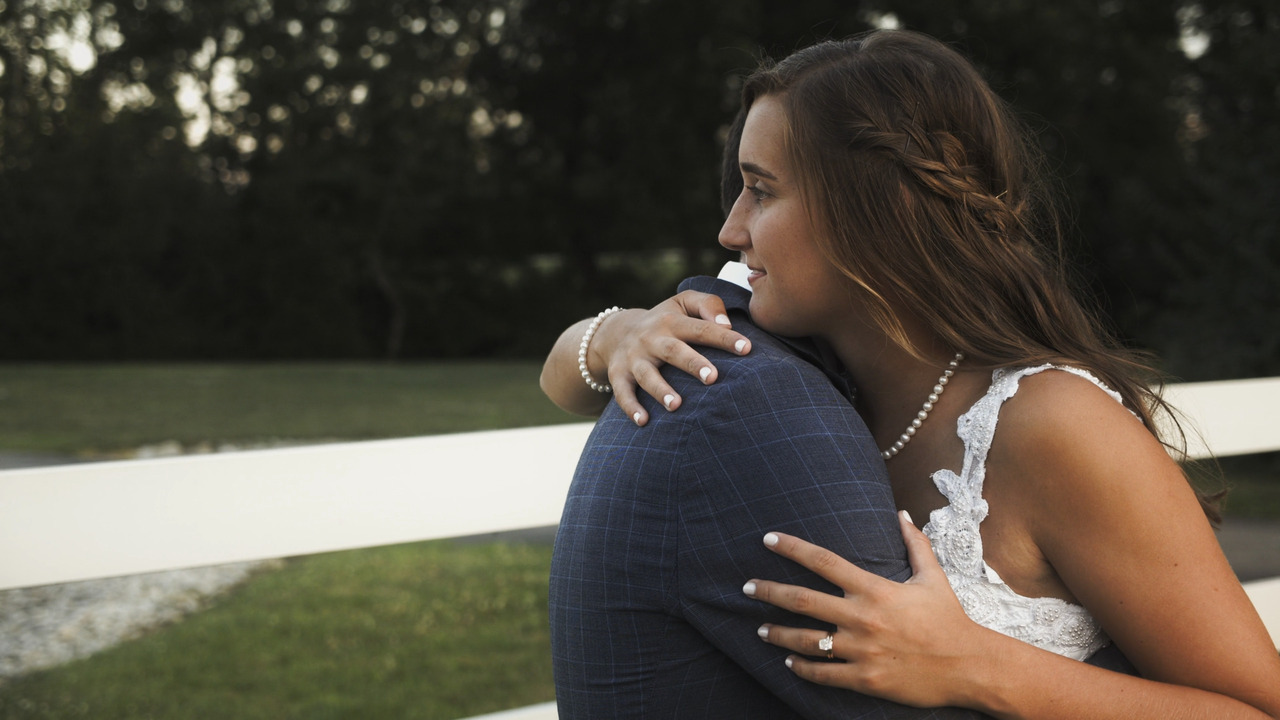 Bride and groom hug.