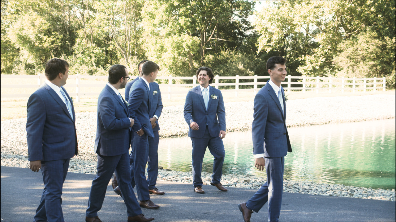 Groom walks with groomsmen.