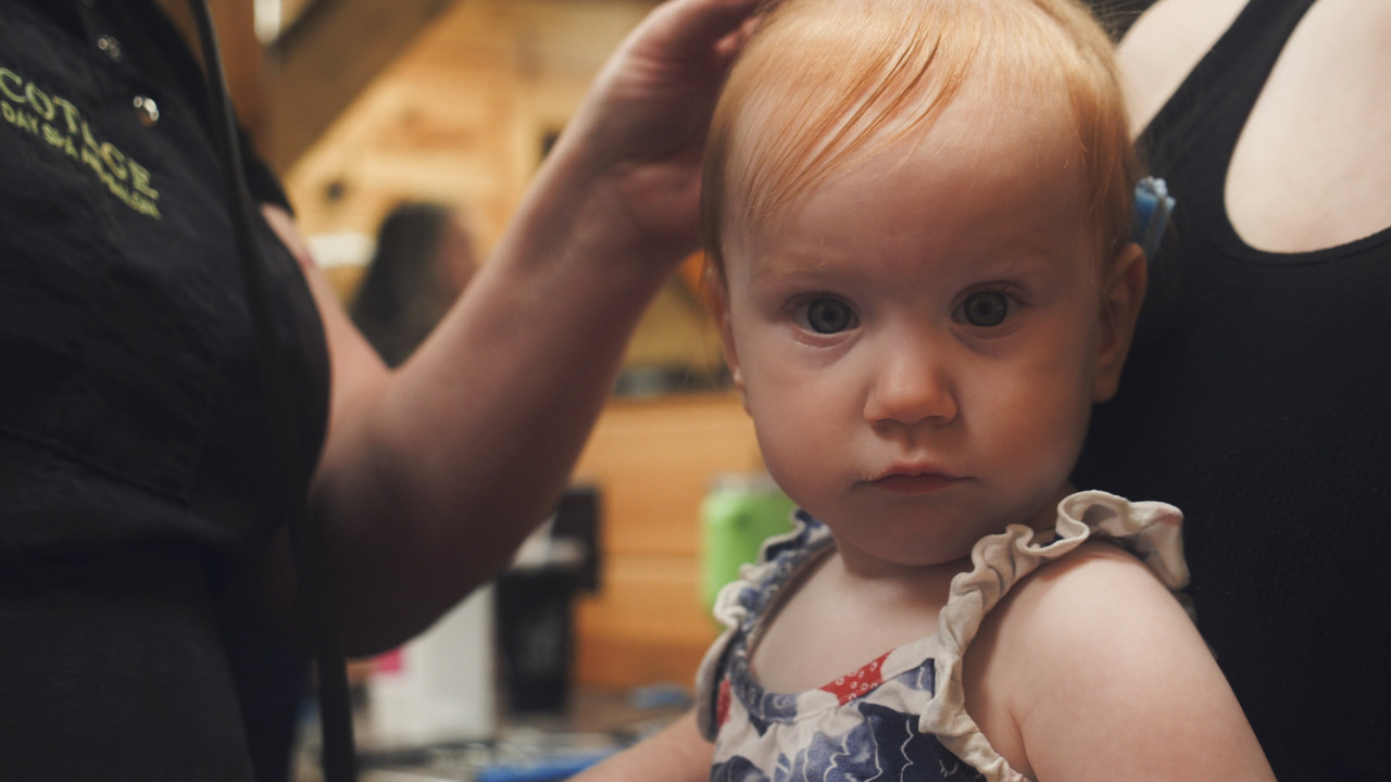 Baby looks at camera, inquisitive.
