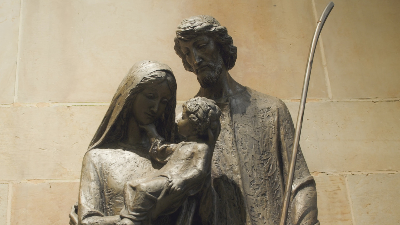 Statue of holy family: St. Joseph, Virgin Mary holding baby Jesus.