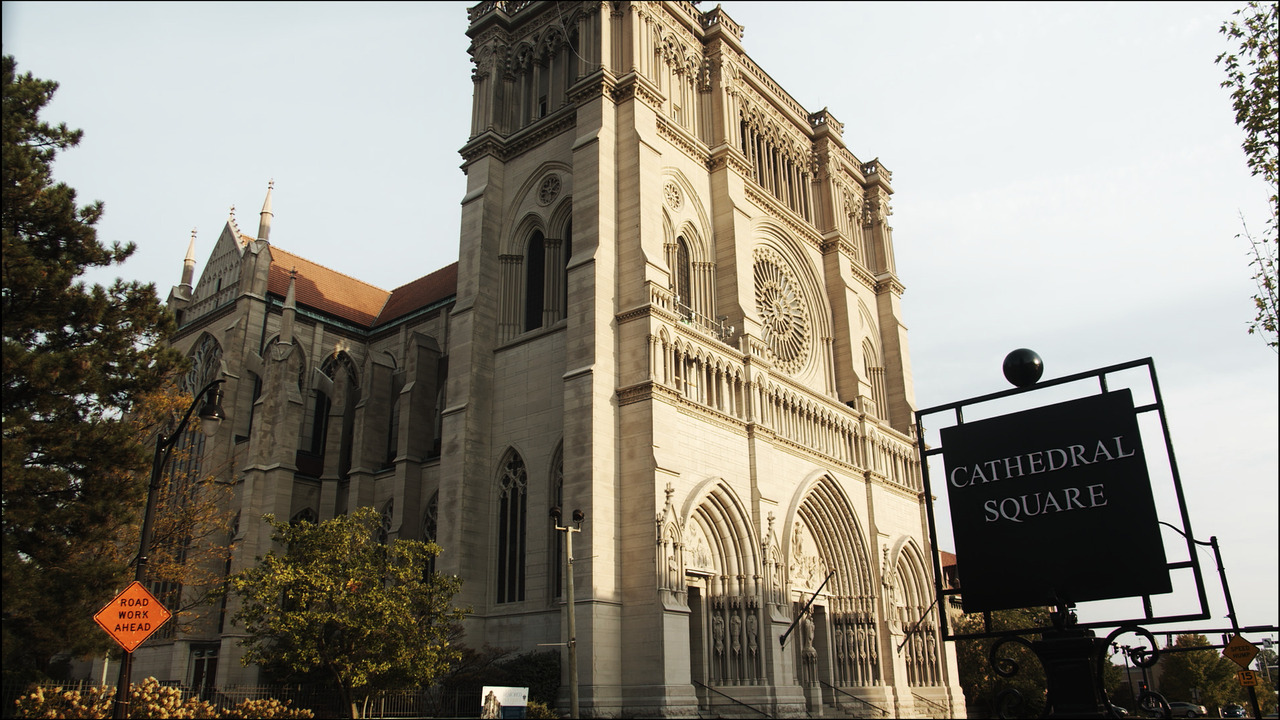 Cathedral front-facing tower facade lit by golden-hour sun.