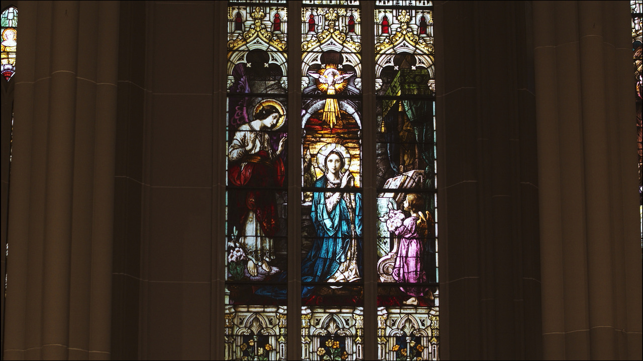 Stained glass window featuring Virgin Mary.
