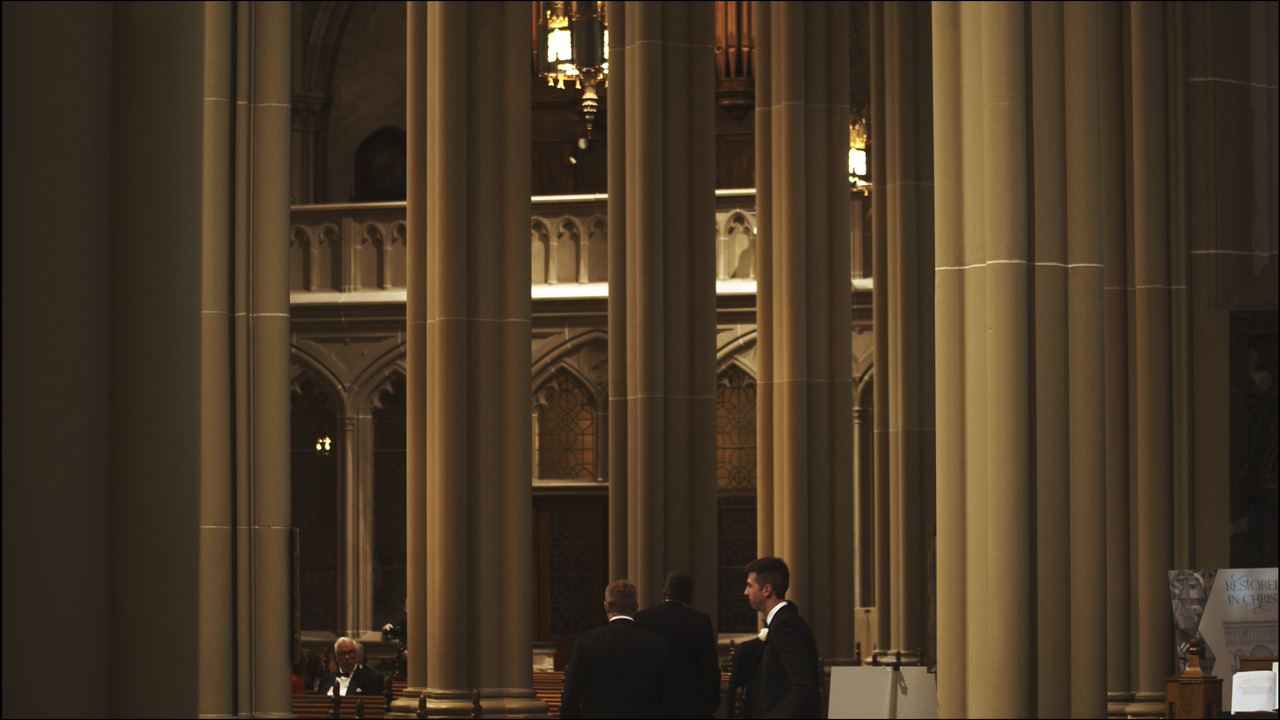 Cathedral columns loom as bridal party enters.