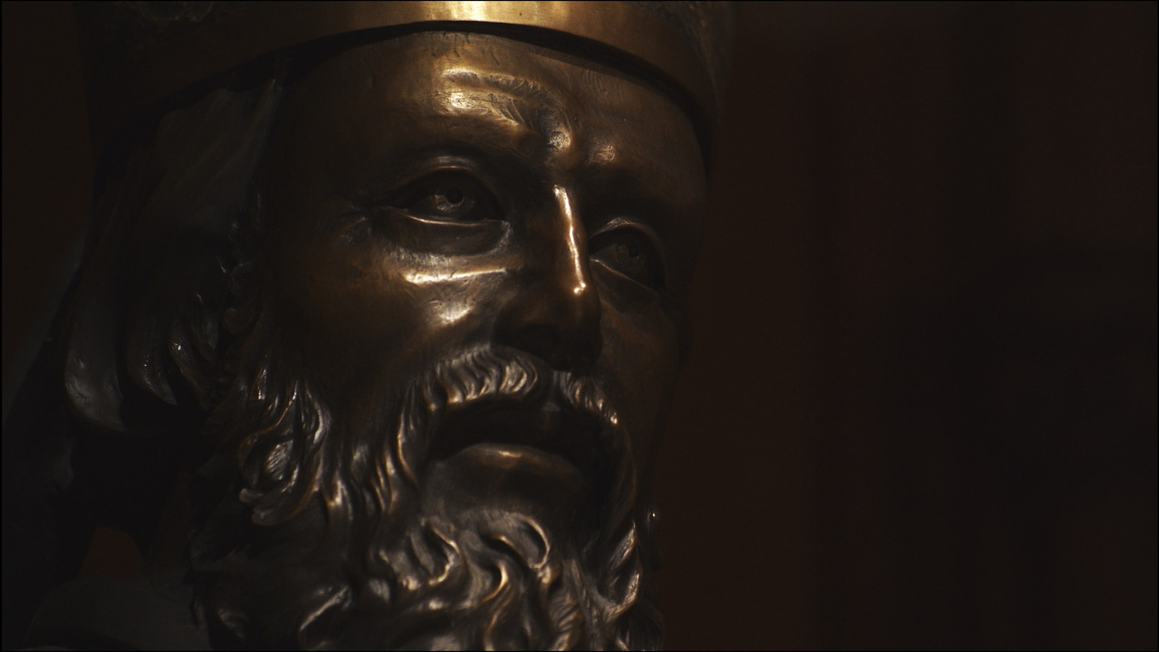 Bronze statue of bearded man.