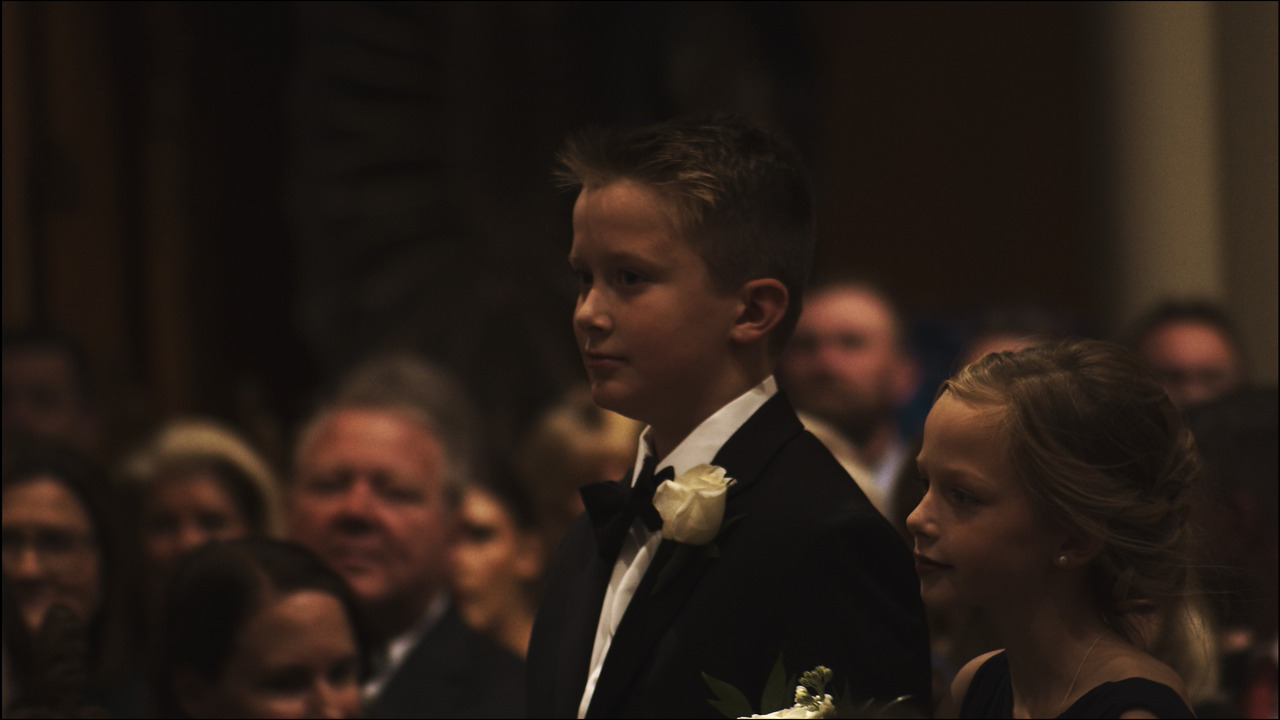 Boy and girl walking down aisle.