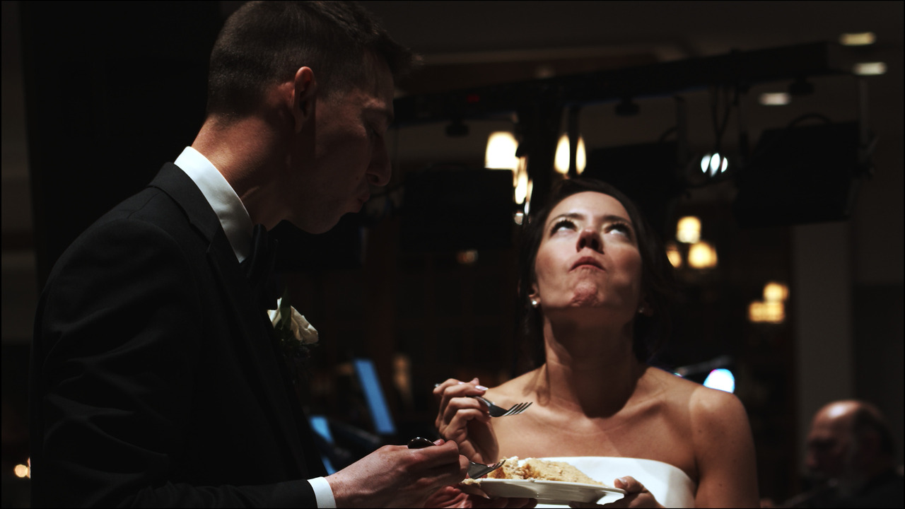 Bride and groom relish wedding cake.