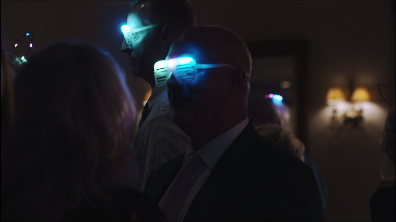 Guests with light-up glasses dancing.