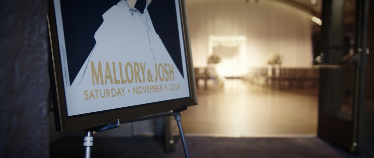 Wedding announcment sign on easel outside main ballroom.