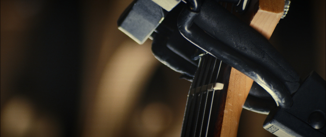 Closeup of the neck of a guitar.