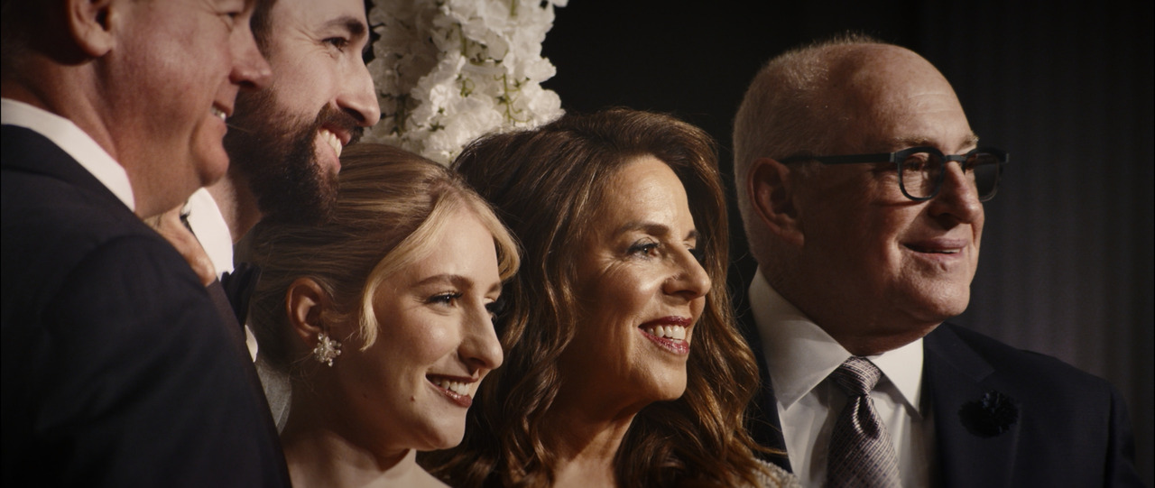 Bride and groom getting photo taken with older family.
