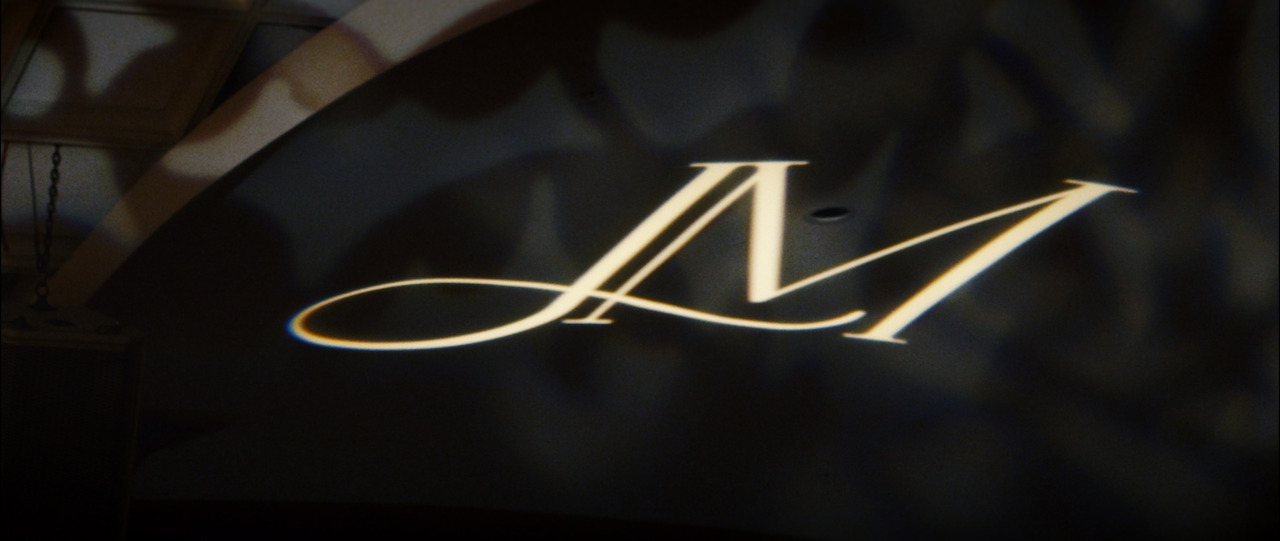 'JM' logo projected onto ballroom ceiling.