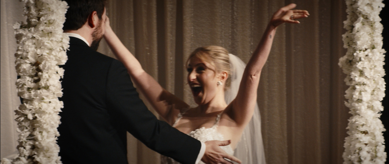 Bride and groom hug.