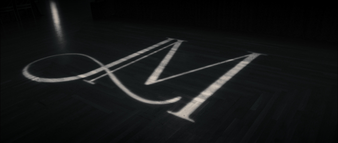 'JM' logo projected onto dance floor.