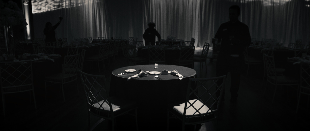 Bride and grooms table illuminated against dark background.