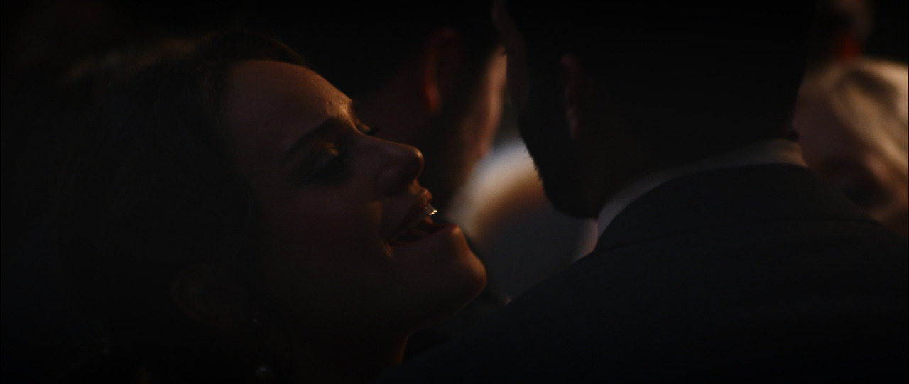 Couple dancing, looking into each other's eyes.