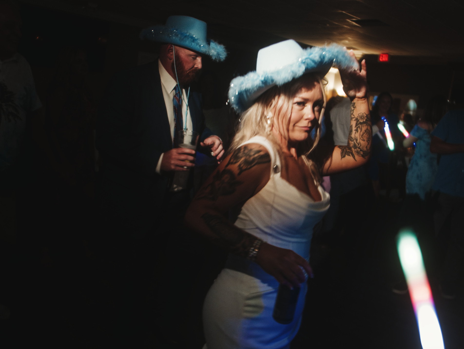 Couple dancing under spotlight.