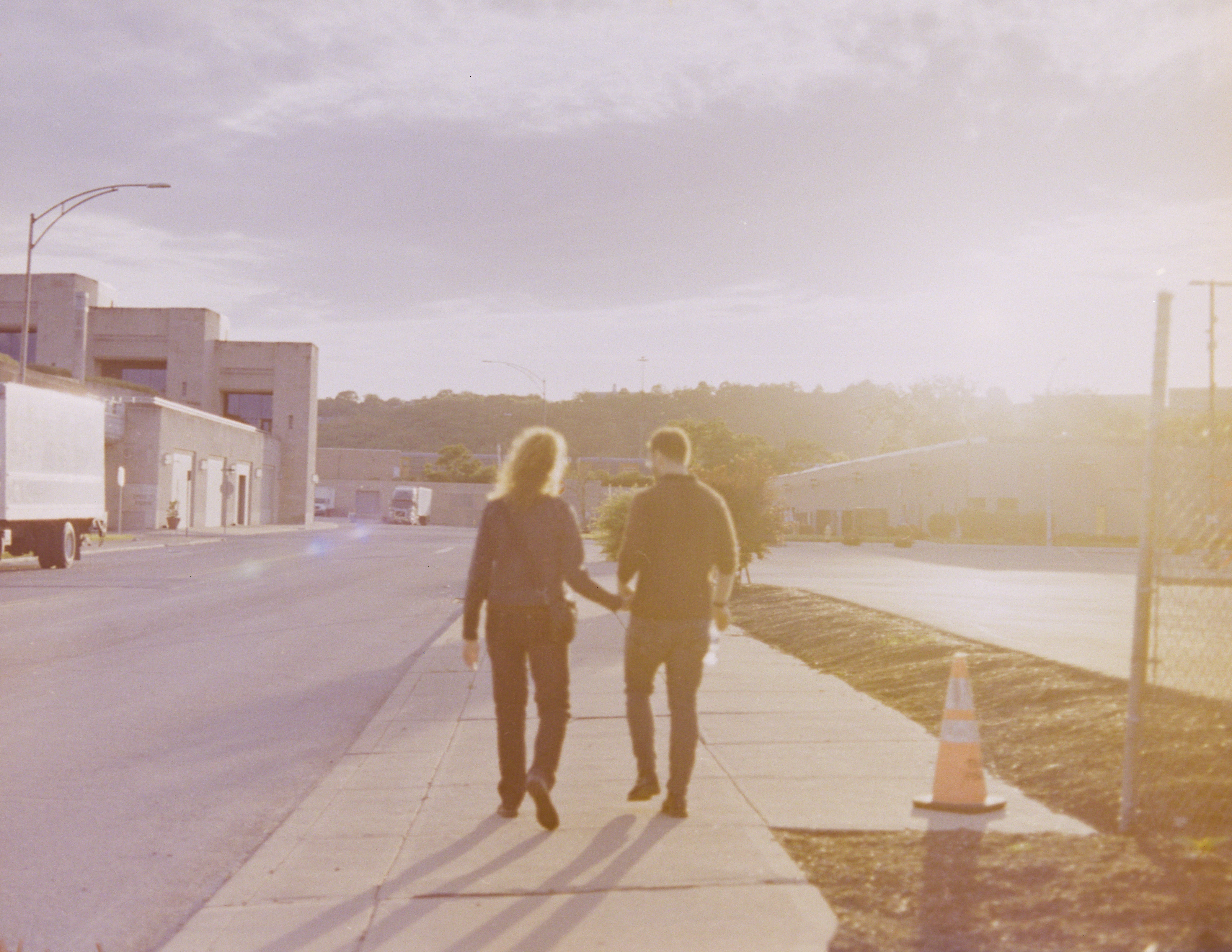Couple walking off into sunset, color.
