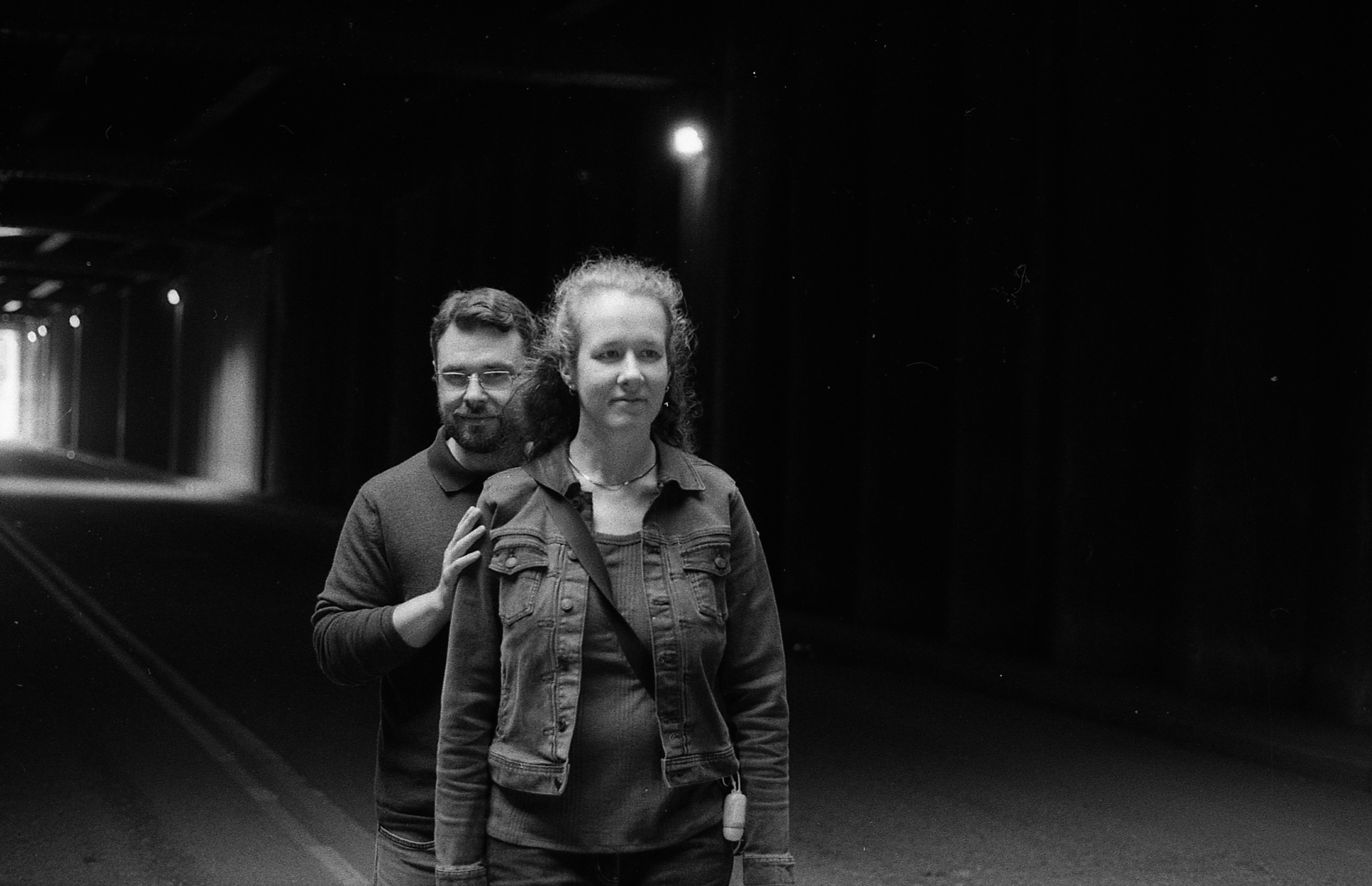 Couple posed in tunnel, black and white.